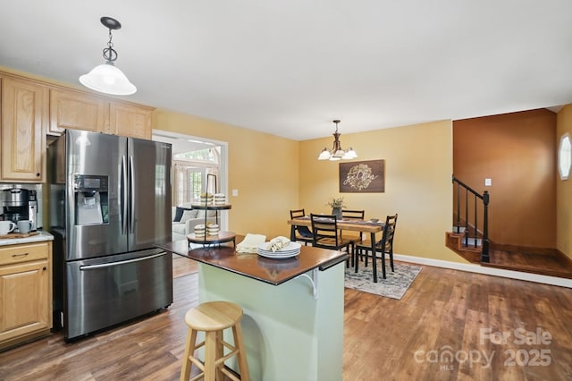 9711 Pine Tree Rd, Norwood, NC 28128 - kitchen featuring light brown cabinets, stainless steel fridge with ice dispenser, dark wood-style flooring, and an inviting chandelier