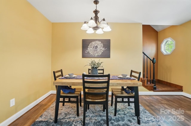9711 Pine Tree Rd, Norwood, NC 28128 - dining area with baseboards, wood finished floors, a chandelier, and stairway