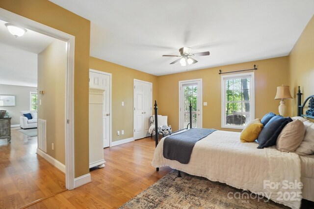 9711 Pine Tree Rd, Norwood, NC 28128 - bedroom with baseboards, access to outside, light wood-style floors, and ceiling fan