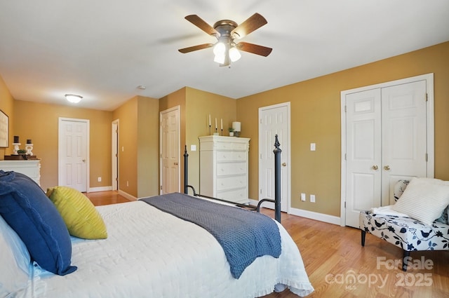 9711 Pine Tree Rd, Norwood, NC 28128 - bedroom featuring baseboards, a ceiling fan, multiple closets, and light wood finished floors