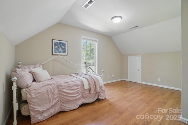 9711 Pine Tree Rd, Norwood, NC 28128 - bedroom with baseboards, lofted ceiling, visible vents, and light wood-type flooring