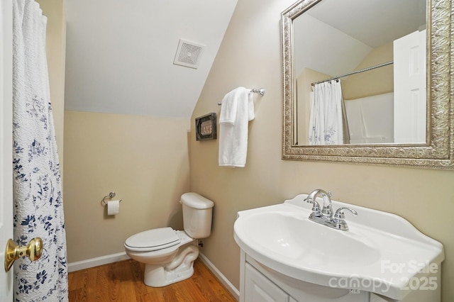 9711 Pine Tree Rd, Norwood, NC 28128 - bathroom with toilet, baseboards, visible vents, lofted ceiling, and wood finished floors