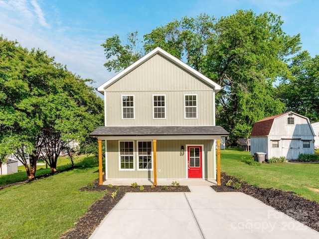 570 Key W Ave, Kannapolis, NC 28081 - view of front of home featuring a shingled roof, a front lawn, a porch, and an outbuilding