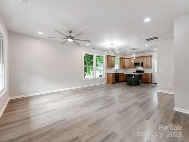 570 Key W Ave, Kannapolis, NC 28081 - unfurnished living room with recessed lighting, baseboards, light wood-type flooring, ceiling fan, and a sink