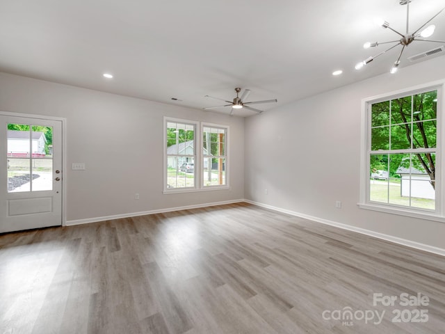 570 Key W Ave, Kannapolis, NC 28081 - spare room featuring plenty of natural light, a chandelier, light wood-style floors, and recessed lighting