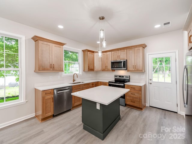 570 Key W Ave, Kannapolis, NC 28081 - kitchen featuring appliances with stainless steel finishes, a sink, light countertops, light wood-style floors, and recessed lighting