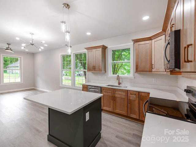 570 Key W Ave, Kannapolis, NC 28081 - kitchen featuring black microwave, a sink, a chandelier, light wood-style floors, and pendant lighting
