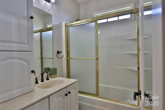 full bath with shower / bath combination with glass door and vanity