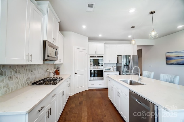 4337 Duplin Dr, Charlotte, NC 28214 - kitchen featuring white cabinets, visible vents, stainless steel appliances, dark wood-type flooring, and a sink