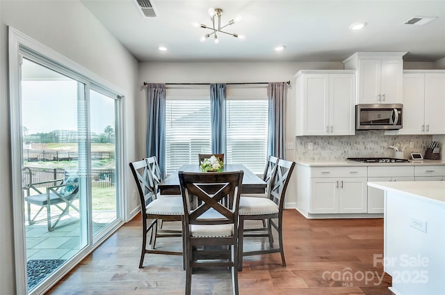 4337 Duplin Dr, Charlotte, NC 28214 - dining area featuring a healthy amount of sunlight, a chandelier, and visible vents