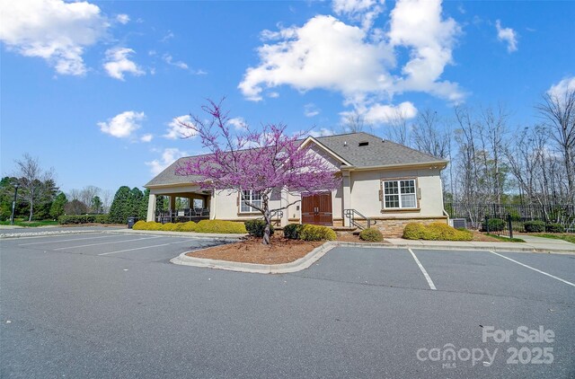 4337 Duplin Dr, Charlotte, NC 28214 - view of front of property featuring uncovered parking, stucco siding, and fence