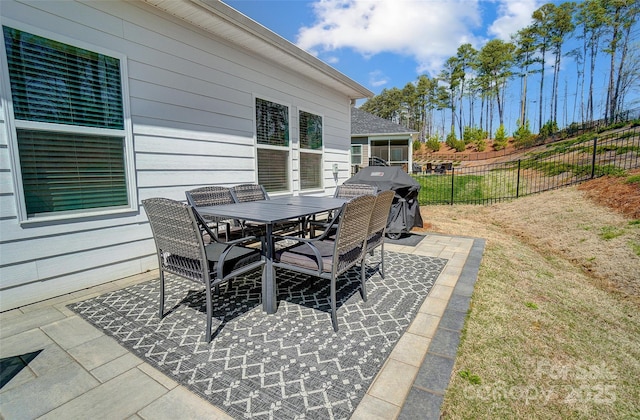 4337 Duplin Dr, Charlotte, NC 28214 - view of patio featuring a grill, outdoor dining area, and fence