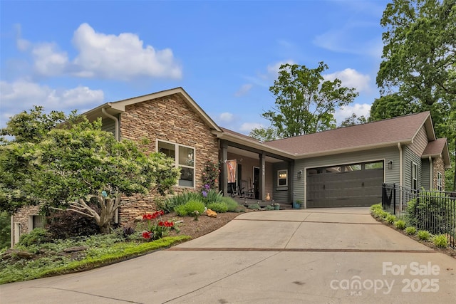 298 Poplar Grove Ct, Taylorsville, NC 28681 - view of front facade with fence, an attached garage, concrete driveway, and stone siding