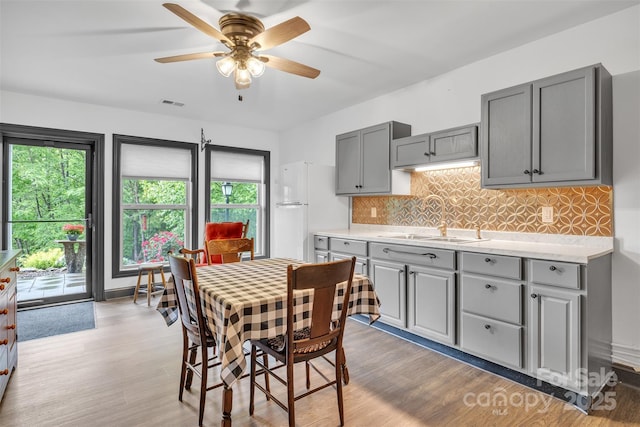 298 Poplar Grove Ct, Taylorsville, NC 28681 - dining area featuring visible vents, light wood finished floors, ceiling fan, and a healthy amount of sunlight