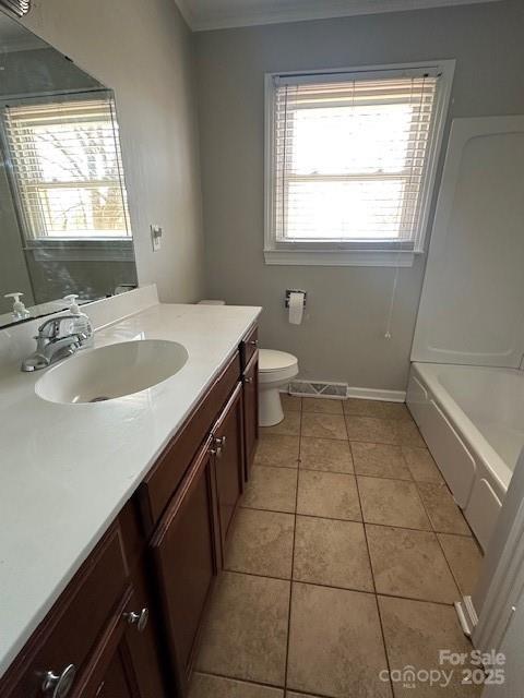 full bath featuring walk in shower, toilet, vanity, a tub, and tile patterned flooring