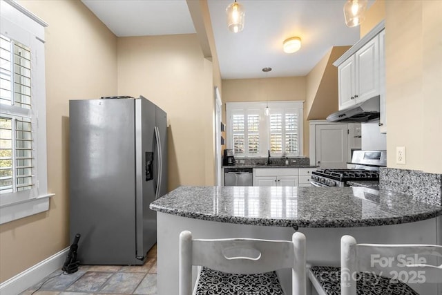 213 S Academy St, Mooresville, NC 28115 - kitchen with a peninsula, plenty of natural light, stainless steel appliances, under cabinet range hood, and a sink