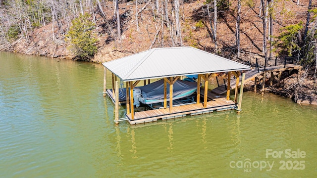 view of dock with boat lift and a water view