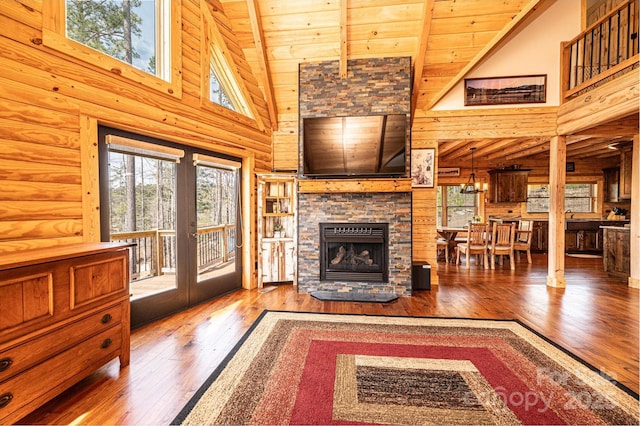 unfurnished living room featuring wood ceiling, a healthy amount of sunlight, high vaulted ceiling, and hardwood / wood-style flooring