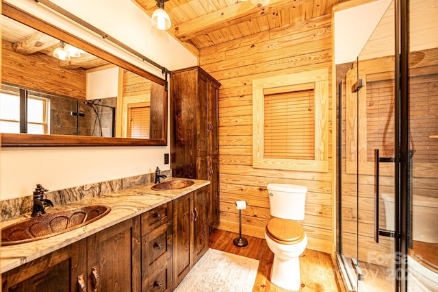 full bath featuring toilet, wood walls, wooden ceiling, and a sink
