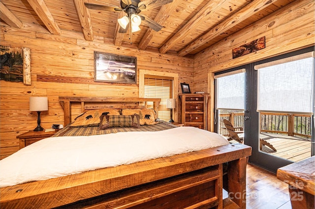 bedroom featuring wood walls, access to exterior, wooden ceiling, wood finished floors, and beamed ceiling