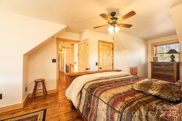 bedroom with baseboards, ceiling fan, and wood finished floors
