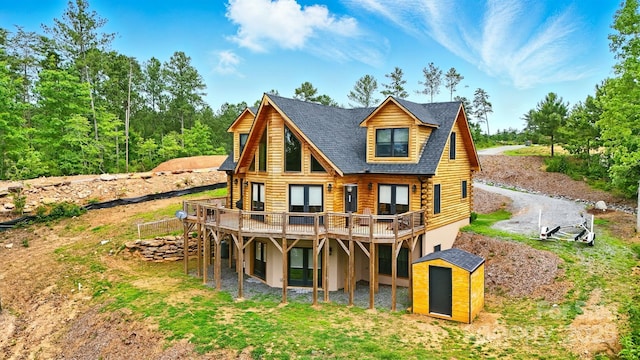 1519 Reflections Edge Dr, Granite Falls, NC 28630 - rear view of house featuring a storage unit, log exterior, a wooden deck, and stucco siding