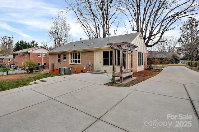 403 Hillcrest Dr, Huntersville, NC 28078 - rear view of house with driveway, brick siding, a pergola, a patio, and central AC unit