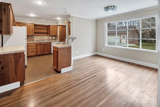 403 Hillcrest Dr, Huntersville, NC 28078 - kitchen featuring brown cabinetry, decorative backsplash, ornamental molding, and open shelves