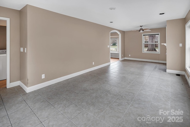 403 Hillcrest Dr, Huntersville, NC 28078 - unfurnished room with baseboards, arched walkways, ceiling fan, and light tile patterned floors