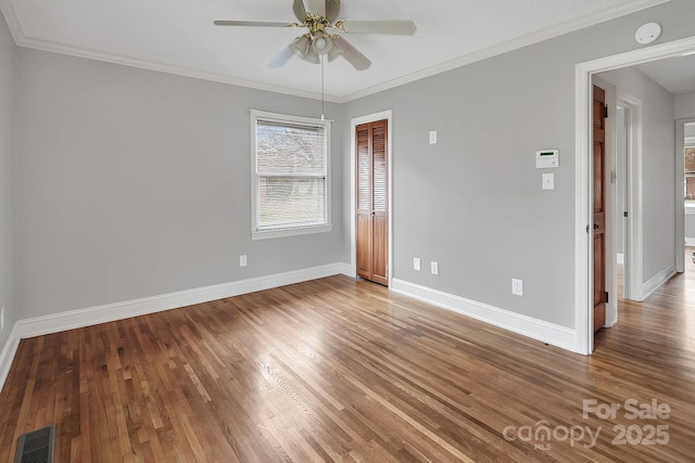 403 Hillcrest Dr, Huntersville, NC 28078 - unfurnished room with visible vents, baseboards, ornamental molding, wood finished floors, and a ceiling fan