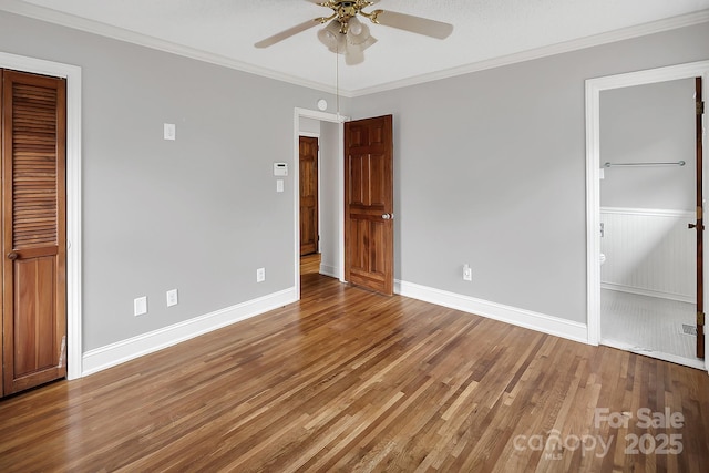 403 Hillcrest Dr, Huntersville, NC 28078 - unfurnished bedroom featuring crown molding, baseboards, connected bathroom, a ceiling fan, and wood finished floors