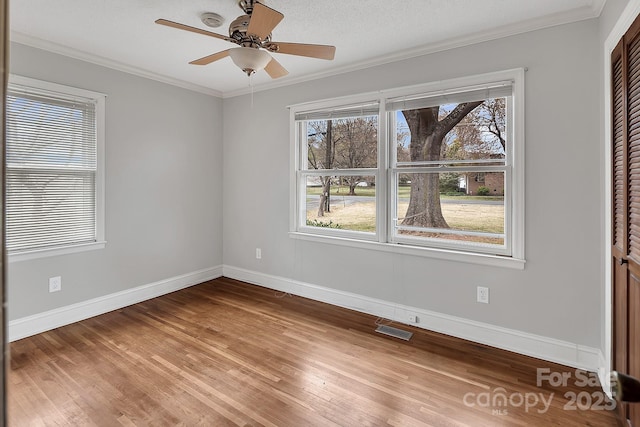 403 Hillcrest Dr, Huntersville, NC 28078 - spare room featuring crown molding, baseboards, visible vents, and light wood-type flooring