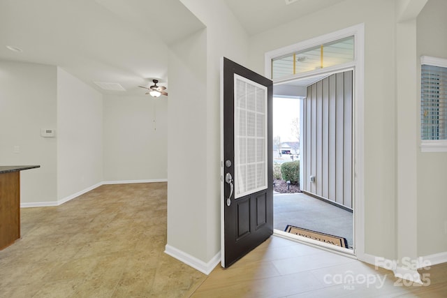entrance foyer with baseboards and ceiling fan