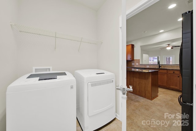 clothes washing area featuring washer and clothes dryer, a sink, a ceiling fan, laundry area, and recessed lighting