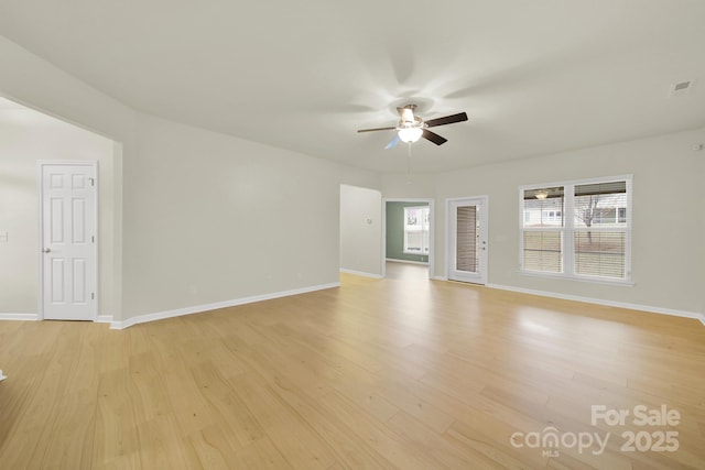 unfurnished living room with a wealth of natural light, light wood-style flooring, and a ceiling fan