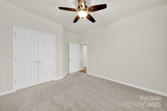 unfurnished bedroom with baseboards, a closet, and carpet