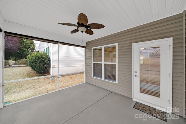 unfurnished sunroom with a ceiling fan