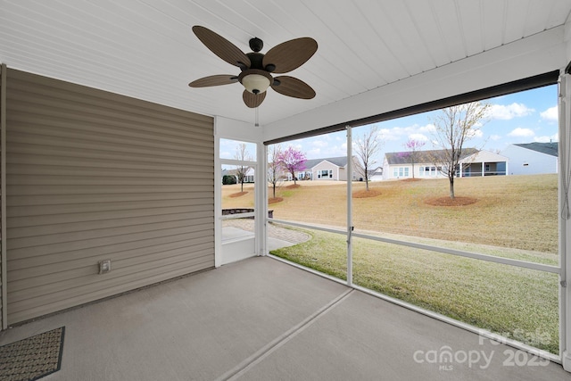 unfurnished sunroom with plenty of natural light and ceiling fan