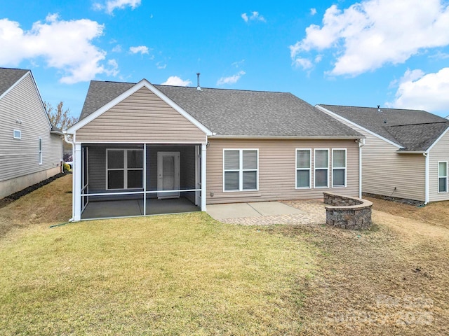 rear view of house with a fire pit, a sunroom, a yard, and a patio
