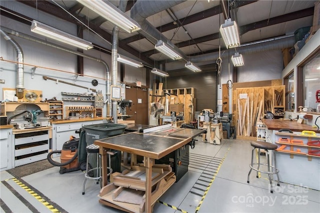 miscellaneous room with concrete floors and a workshop area