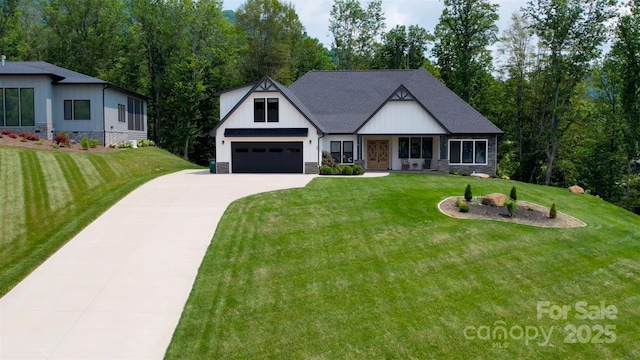 20 Slate Dr, Candler, NC 28715 - view of front of house with concrete driveway, a front yard, a garage, and stone siding