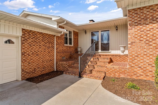 3829 Norman Rd, Morganton, NC 28655 - view of exterior entry with a chimney, a garage, brick siding, and a patio