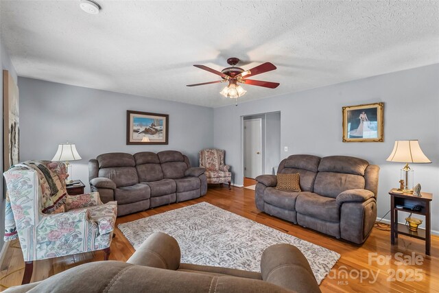 3829 Norman Rd, Morganton, NC 28655 - living area featuring a ceiling fan, a textured ceiling, baseboards, and wood finished floors