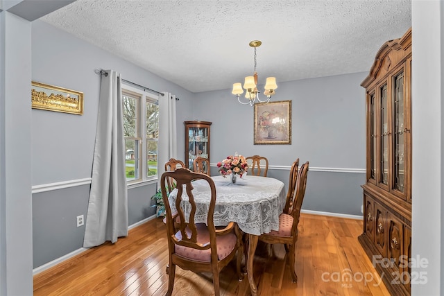3829 Norman Rd, Morganton, NC 28655 - dining room with a textured ceiling, light wood-style floors, baseboards, and a chandelier