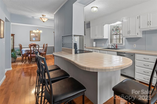 3829 Norman Rd, Morganton, NC 28655 - kitchen with dishwasher, a sink, white cabinetry, and tile countertops