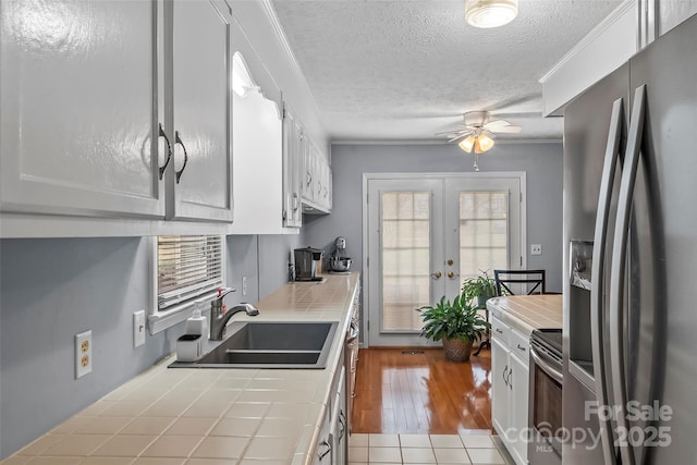 3829 Norman Rd, Morganton, NC 28655 - kitchen featuring french doors, a sink, appliances with stainless steel finishes, tile countertops, and ceiling fan