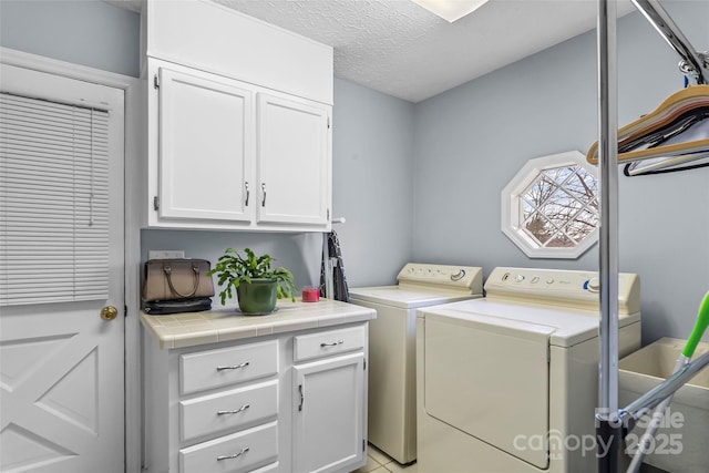3829 Norman Rd, Morganton, NC 28655 - laundry room with independent washer and dryer, cabinet space, and a textured ceiling