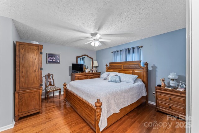 3829 Norman Rd, Morganton, NC 28655 - bedroom with baseboards, a ceiling fan, light wood-style floors, and a textured ceiling