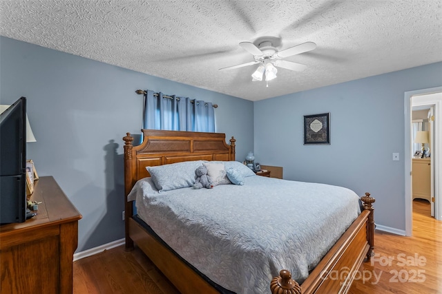 3829 Norman Rd, Morganton, NC 28655 - bedroom featuring light wood finished floors, baseboards, ceiling fan, and a textured ceiling