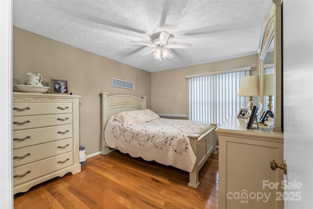 3829 Norman Rd, Morganton, NC 28655 - bedroom featuring a ceiling fan, light wood-style flooring, and a textured ceiling
